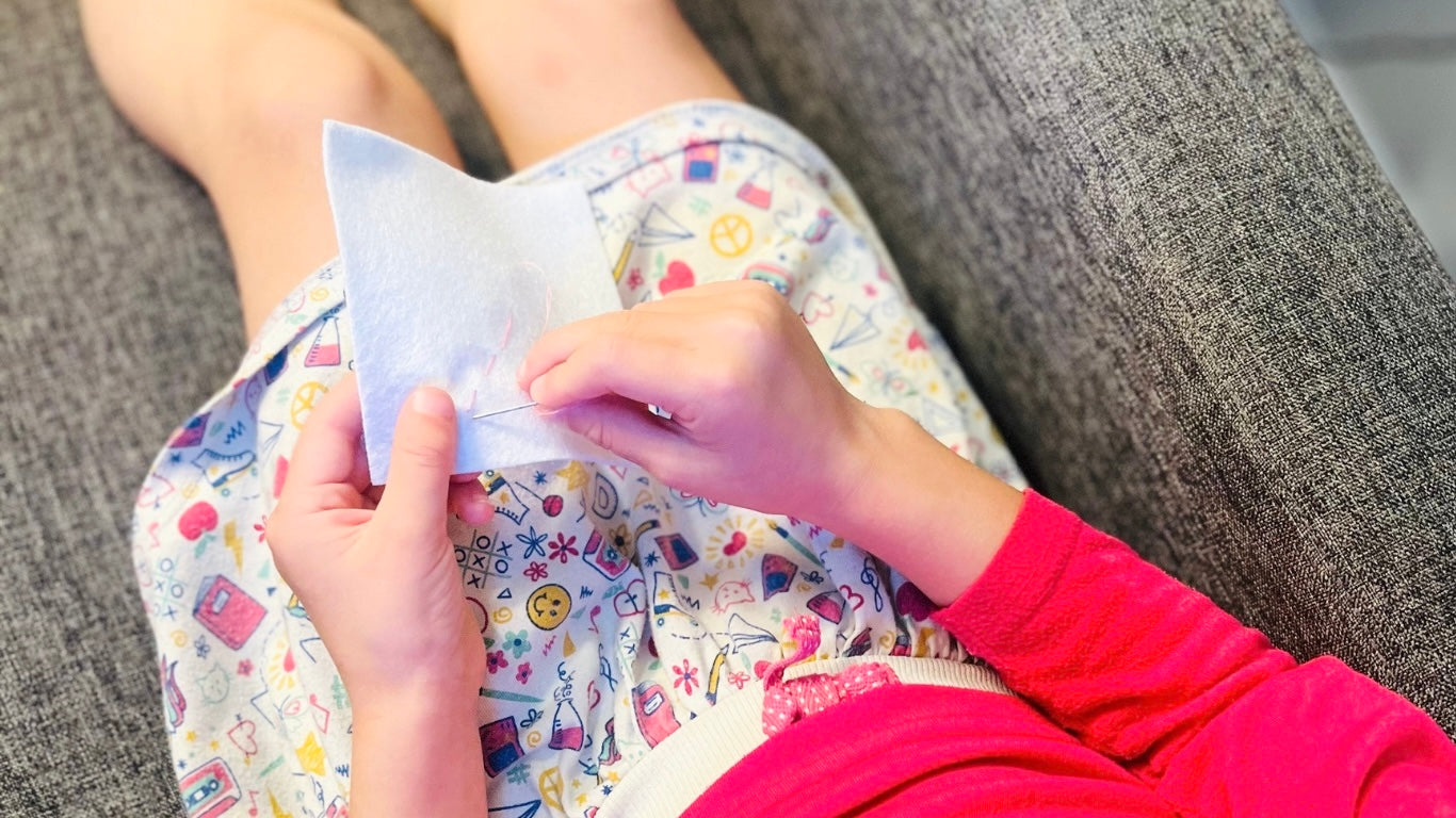 five year old girl sewing 