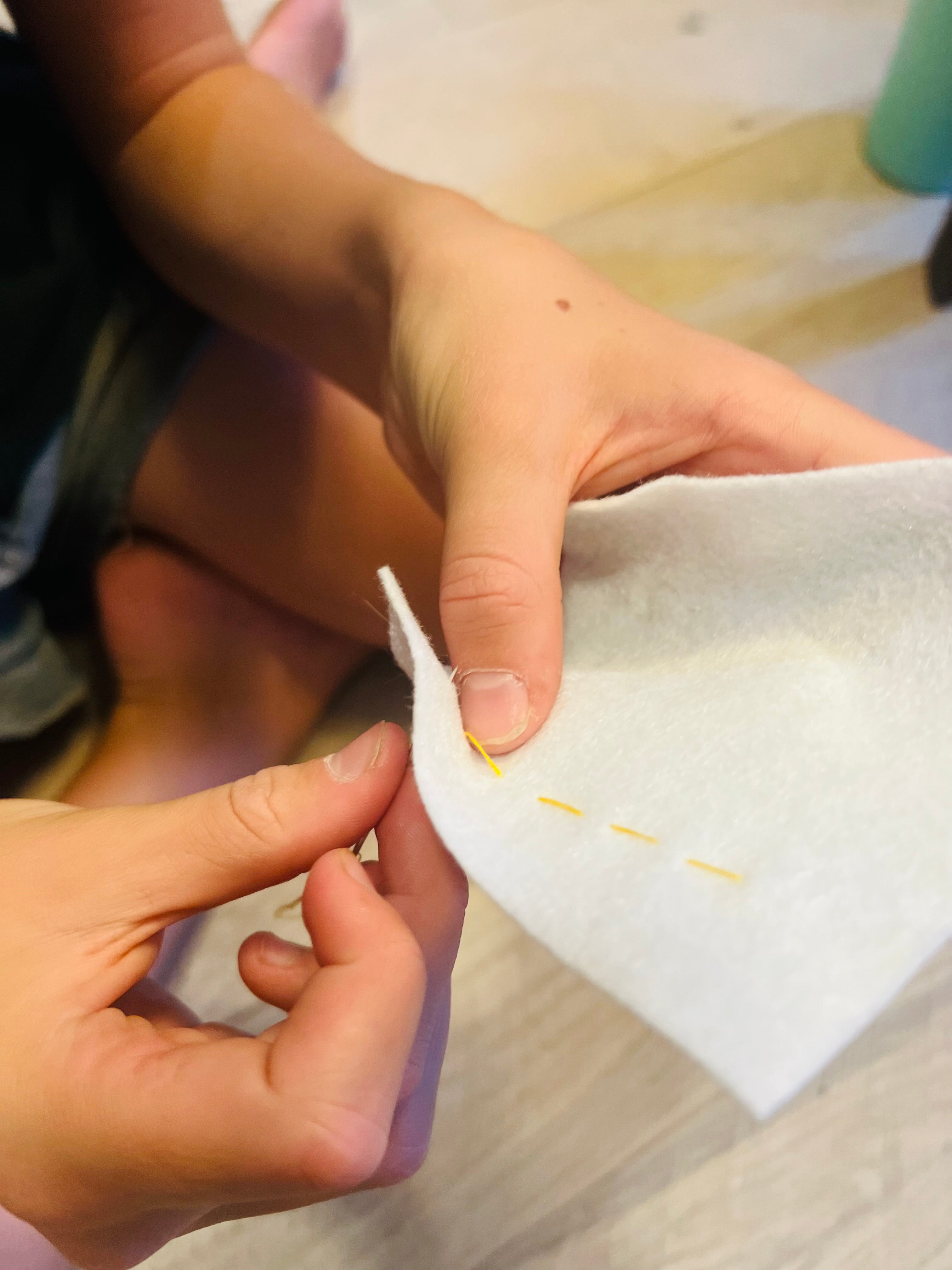 girl learning to sew